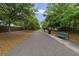 Scenic walking path lined with trees and a bench, offering a serene outdoor experience at 4839 Jackstaff Way, Oviedo, FL 32765