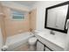 Updated bathroom with tiled shower/tub, modern vanity and fixtures, and a large mirror at 5134 Harvard W St, Lakeland, FL 33810