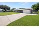 Charming home featuring a long driveway, well-maintained lawn, and an attached two-car garage at 5134 Harvard W St, Lakeland, FL 33810