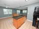 Large kitchen featuring wood cabinets, island and breakfast bar, black appliances, and tiled floors at 5134 Harvard W St, Lakeland, FL 33810