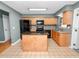 A spacious kitchen featuring wood cabinets, black appliances, and a center island for modern cooking at 5134 Harvard W St, Lakeland, FL 33810