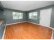 Living room featuring wood laminate flooring, natural light, and a white front door at 5134 Harvard W St, Lakeland, FL 33810