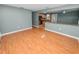 Open floor plan view of the living room connecting to the kitchen with laminate flooring at 5134 Harvard W St, Lakeland, FL 33810