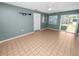 Bright and airy living room featuring tile flooring and a sliding glass door to the outside at 5134 Harvard W St, Lakeland, FL 33810