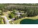 Waterfront home on large lot with screened pool, lush landscaping, and wooded perimeter at 5200 Carson St, St Cloud, FL 34771