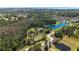 Aerial view of the lakefront community surrounding an estate home, nestled among the trees at 5200 Carson St, St Cloud, FL 34771