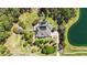 Expansive property featuring a screened pool, lush landscaping, and a private pond at 5200 Carson St, St Cloud, FL 34771