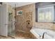 This primary bath features a large tub with decorative tile and a walk-in shower at 5200 Carson St, St Cloud, FL 34771