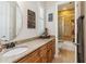 Well-lit bathroom featuring granite counters and a glass-enclosed shower at 5200 Carson St, St Cloud, FL 34771