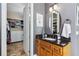 This bathroom has a wooden vanity, granite countertop and is connected to a walk-in closet at 5200 Carson St, St Cloud, FL 34771