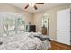 Comfortable bedroom with hardwood floors and an attached bathroom at 5200 Carson St, St Cloud, FL 34771
