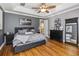 This bedroom features hard wood floors, a tray ceiling, and neutral decor at 5200 Carson St, St Cloud, FL 34771