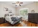Cozy bedroom with hardwood floors, shuttered windows, and farm animal themed decor at 5200 Carson St, St Cloud, FL 34771