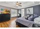 This bedroom features hardwood floors, tray ceilings and a TV over the dresser at 5200 Carson St, St Cloud, FL 34771