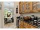 Butler's Pantry with dark granite counters, wine fridge, and wood cabinetry at 5200 Carson St, St Cloud, FL 34771