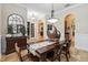 Stylish dining room featuring hardwood table and chairs with arched doorways and decorative decor at 5200 Carson St, St Cloud, FL 34771