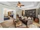 Spacious living room with tile floors, leather furniture, and access to the kitchen at 5200 Carson St, St Cloud, FL 34771