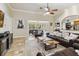 Bright living room with tile floors, ceiling fan, and views of the screened porch at 5200 Carson St, St Cloud, FL 34771