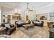 Open-concept living room with tile floors and a comfortable seating arrangement at 5200 Carson St, St Cloud, FL 34771