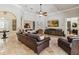 Spacious living room with tile floors, ceiling fan, and comfortable leather furniture at 5200 Carson St, St Cloud, FL 34771