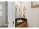 Cozy powder room with wood vanity, granite countertop, and decorative accents at 5200 Carson St, St Cloud, FL 34771