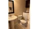 Bathroom with modern pedestal sink and toilet next to laundry at 5334 Bamboo Ct # 463, Orlando, FL 32811