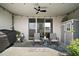 Covered back porch featuring seating, a ceiling fan, and string lights for outdoor enjoyment at 5367 Pinecone Ct, Wildwood, FL 34785