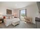 Bright bedroom with large window, neutral color palette, padded bench, and wooden desk at 5367 Pinecone Ct, Wildwood, FL 34785