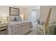 Calm bedroom with neutral color palette and patterned bedding featuring a full length mirror at 5367 Pinecone Ct, Wildwood, FL 34785