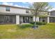 Rear exterior showcasing a private backyard with a covered patio, perfect for outdoor living at 5367 Pinecone Ct, Wildwood, FL 34785