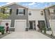 Two-story townhome with a one-car garage and well-maintained landscaping and driveway at 5367 Pinecone Ct, Wildwood, FL 34785