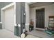 Inviting covered front entryway with landscaping and view of the garage at 5367 Pinecone Ct, Wildwood, FL 34785