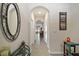Bright hallway featuring tile flooring and arched doorways at 5367 Pinecone Ct, Wildwood, FL 34785