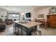 Open concept kitchen featuring island with sink and seating, dining area, and living room at 5367 Pinecone Ct, Wildwood, FL 34785