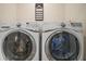 Well-equipped laundry room featuring a modern, front-load washer and dryer at 5367 Pinecone Ct, Wildwood, FL 34785
