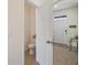 Compact powder room next to front entry and door with tiled floor at 5367 Pinecone Ct, Wildwood, FL 34785