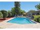 Inviting backyard pool with lounge chairs, screened-in lanai, and lush landscaping at 5441 Justine Way, Winter Park, FL 32792
