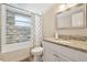 Bathroom with shower-tub combo, decorative tile backsplash, and granite countertops at 5441 Justine Way, Winter Park, FL 32792