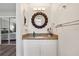 Updated bathroom vanity with granite countertop, bronze mirror, and decorative lighting at 5441 Justine Way, Winter Park, FL 32792