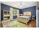 Cozy bedroom with hardwood floors, ceiling fan, and modern decor at 5441 Justine Way, Winter Park, FL 32792