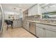Well-lit kitchen with stainless steel appliances, breakfast bar, and updated tile flooring at 5441 Justine Way, Winter Park, FL 32792