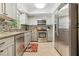 Well-equipped kitchen featuring stainless steel appliances, granite countertops, and tiled backsplash at 5441 Justine Way, Winter Park, FL 32792