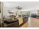Open-concept living room featuring tile flooring, ceiling fan, and a mounted TV at 5441 Justine Way, Winter Park, FL 32792