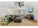 Spacious living room featuring tile flooring, ceiling fan, a large sectional, and a flat screen TV at 5441 Justine Way, Winter Park, FL 32792