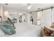 Comfortable main bedroom with ceiling fan, barn-door access to bathroom, and closet with mirrored doors at 5441 Justine Way, Winter Park, FL 32792