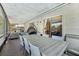 Covered patio featuring a dining table, stylish furniture, and sliding glass doors to the interior at 5441 Justine Way, Winter Park, FL 32792