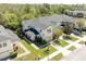 Aerial view of townhomes with well-manicured lawns and landscaping at 5565 Gelato Dr, Orlando, FL 32829