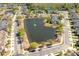 An aerial view of multi-Gathering homes surrounding a picturesque lake with a fountain feature at 5565 Gelato Dr, Orlando, FL 32829