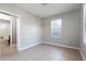 Neutral bedroom featuring tile floors, a large window, and an adjoining bathroom at 5565 Gelato Dr, Orlando, FL 32829