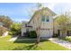 Attractive two-story townhouse featuring a two-car garage and lush green landscaping at 5565 Gelato Dr, Orlando, FL 32829